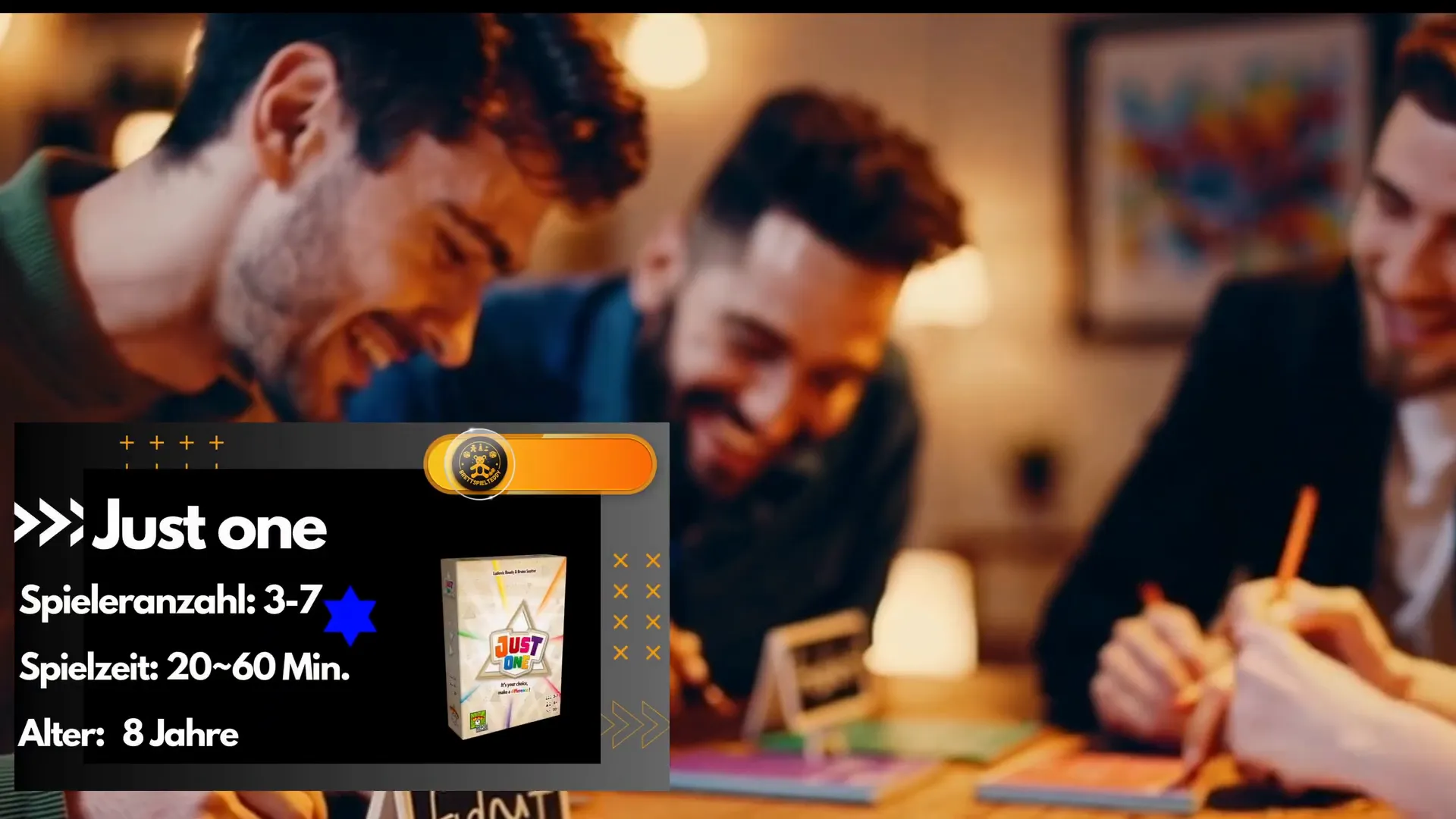 Just One Karton und Spielmaterial auf einem Tisch
